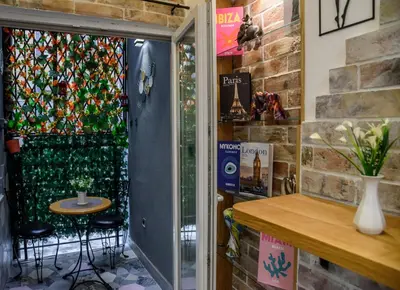 a room with a glass door with a table and chairs at Skadarlija Aurora in Belgrade