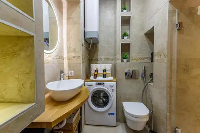 a bathroom with a washing machine and a sink at Skadarlija Aurora in Belgrade