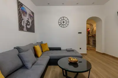 a living room with a couch and a table at Skadarlija Aurora in Belgrade