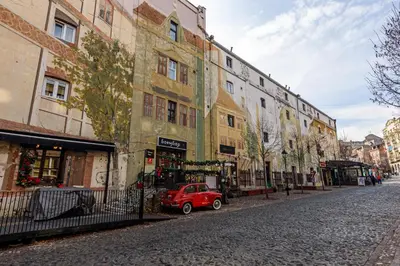 a small red car parked in front of a building at Skadarlija Aurora in Belgrade