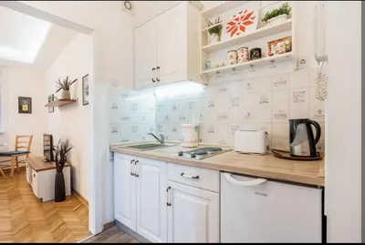 a kitchen with white cabinets and a counter top at Balkan-inn Apartment Terazije 2 in Belgrade