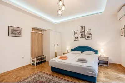 a bedroom with a large bed in a room at Balkan-inn Apartment Terazije 2 in Belgrade