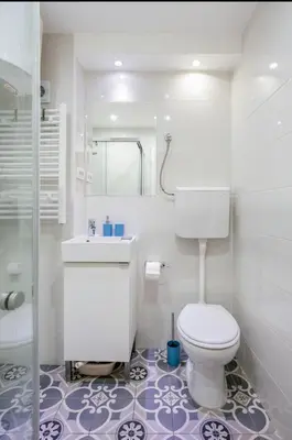 a white bathroom with a toilet and a sink at Balkan-inn Apartment Terazije 2 in Belgrade