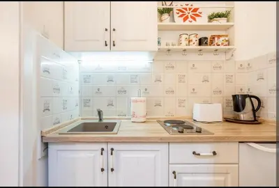 a kitchen with white cabinets and a sink at Balkan-inn Apartment Terazije 2 in Belgrade