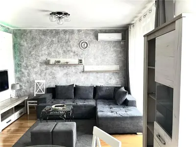 a living room with a couch and a table at Cosy Retreat 135 in Belgrade