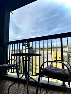 a table and two chairs on a balcony with a view at Cosy Retreat 135 in Belgrade