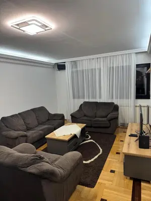 a living room with two couches and a table at Apartman Centar in Obrenovac