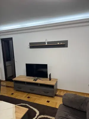 a living room with a flat screen tv on a wall at Apartman Centar in Obrenovac