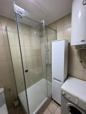 a shower with a glass door in a bathroom at Apartman Centar in Obrenovac