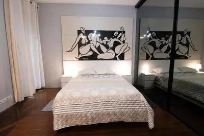 a bedroom with a bed and a picture on the wall at Astra Apartment in Belgrade