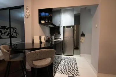 a kitchen with a table and a refrigerator at Astra Apartment in Belgrade