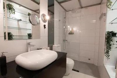 a white bathroom with a sink and a toilet at Astra Apartment in Belgrade