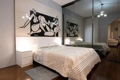 a bedroom with a bed and a mirrored wall at Astra Apartment in Belgrade
