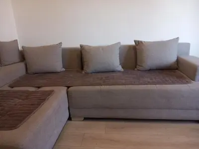 a couch with pillows on it in a living room at Djordje in Belgrade
