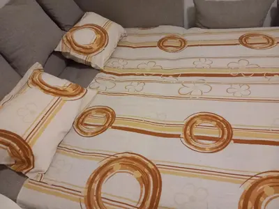 a bed with three pillows on top of it at Djordje in Belgrade