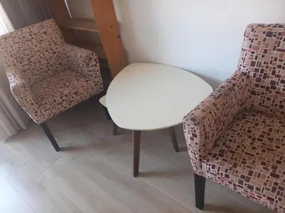 a white table and a chair in a room at Djordje in Belgrade
