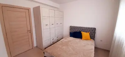 a small bedroom with a bed and a closet at Apartman Vojvoda in Belgrade