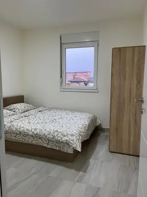 a bedroom with a bed and a window at Airport Art Villa in Surčin