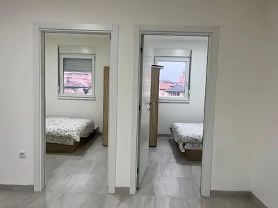 a room with two beds and two windows at Airport Art Villa in Surčin