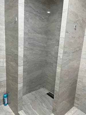 a shower in a bathroom with a beige at Airport Art Villa in Surčin