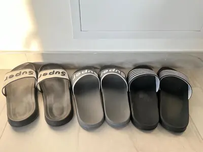 a row of pairs of shoes in a drawer at Airport Art Villa in Surčin