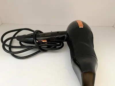 a black blow dryer sitting on a counter at Airport Art Villa in Surčin