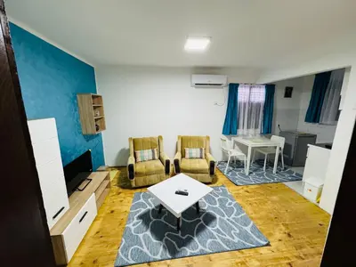 a living room with two chairs and a table at Vračarska kućica in Belgrade