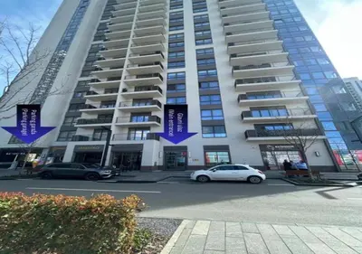 a large building with cars parked in front of it at BW Arcadia Apartments - Beograd na vodi in Belgrade