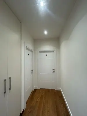 an empty hallway with two white doors and wood floors at BW Arcadia Apartments - Beograd na vodi in Belgrade