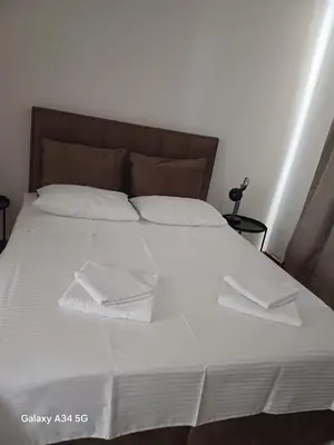 a bed with white sheets and pillows on it at BW Arcadia Apartments - Beograd na vodi in Belgrade