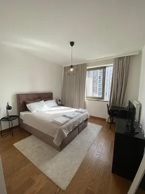 a bedroom with a large bed and a desk at BW Arcadia Apartments - Beograd na vodi in Belgrade