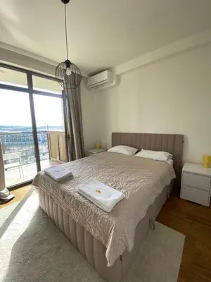 a bedroom with a bed with two towels on it at BW Arcadia Apartments - Beograd na vodi in Belgrade