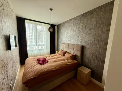 a bedroom with a bed with a flower on it at Q4 Comfort Apartment in Belgrade