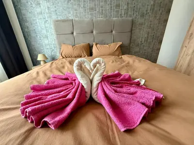 two towels in the shape of two hearts on a bed at Q4 Comfort Apartment in Belgrade