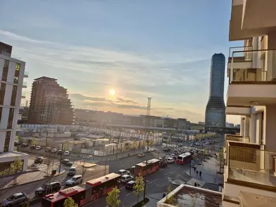 a view of a city street with buses and cars at Q4 Comfort Apartment in Belgrade