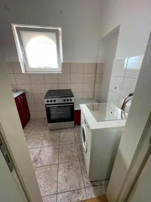 a small kitchen with a stove and a sink at Sunlight House in Belgrade