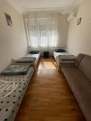 a living room with three beds and a couch at Sunlight House in Belgrade