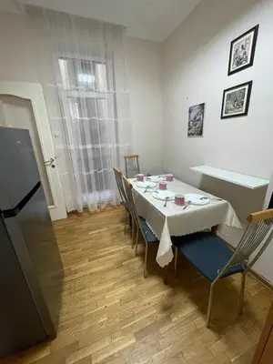 a dining room with a white table and chairs at Sunlight House in Belgrade
