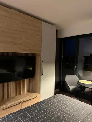 a bedroom with a bed and a chair and a table at Apartment Cvijiceva - Park view in Belgrade