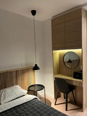 a bedroom with a bed and a desk and a mirror at Apartment Cvijiceva - Park view in Belgrade