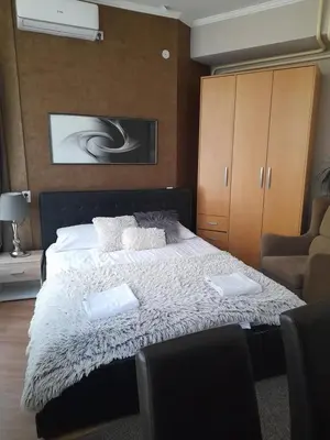 a bedroom with a bed with two pillows on it at Visoki Stevan Apartments in Belgrade