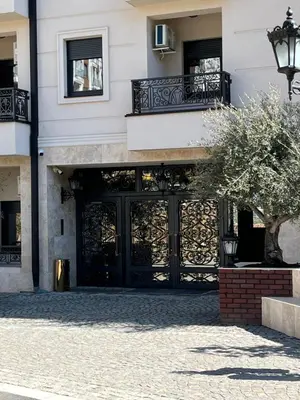 a building with a black door and a balcony at Magnolia in Belgrade