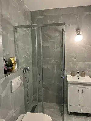 a bathroom with a shower and a toilet and a sink at Magnolia in Belgrade