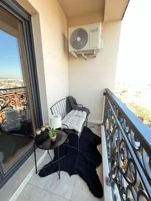 a balcony with a table and a chair on a balcony at Magnolia in Belgrade
