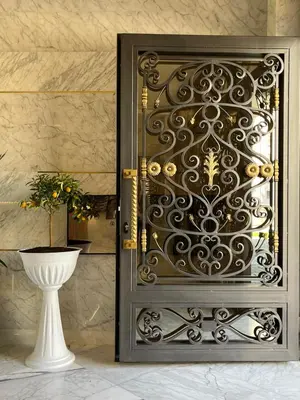 a metal door with a vase in a room at Magnolia in Belgrade
