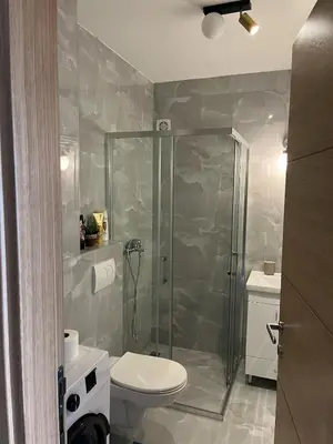 a bathroom with a shower and a toilet and a sink at Magnolia in Belgrade