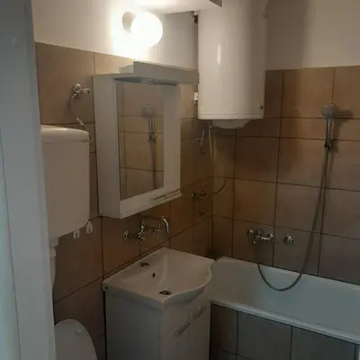 a bathroom with a toilet and a sink and a tub at Apartman Tanja in Arandjelovac