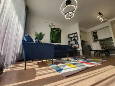 a living room with a blue couch and a rug at BW Aqua LUX, river view, parking free in Belgrade