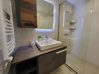 a bathroom with a white sink and a shower at BW Aqua LUX, river view, parking free in Belgrade