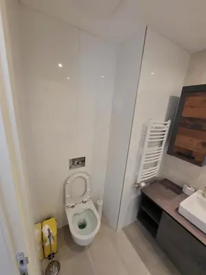 a small bathroom with a toilet and a sink at BW Aqua LUX, river view, parking free in Belgrade